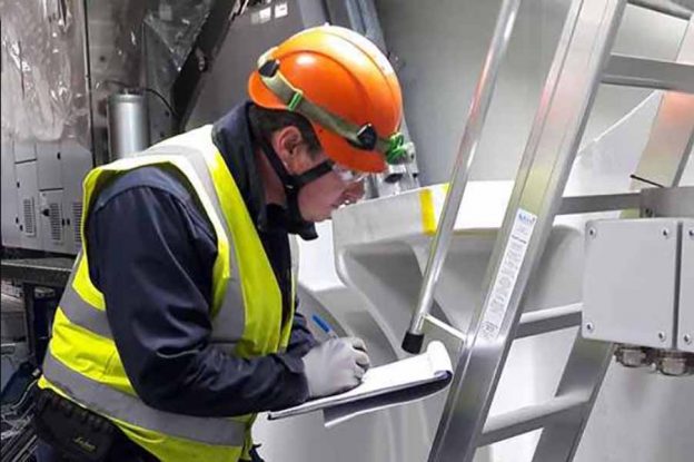 A worker inspecting a ladder in use