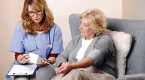 A carer checking the BP of a lady